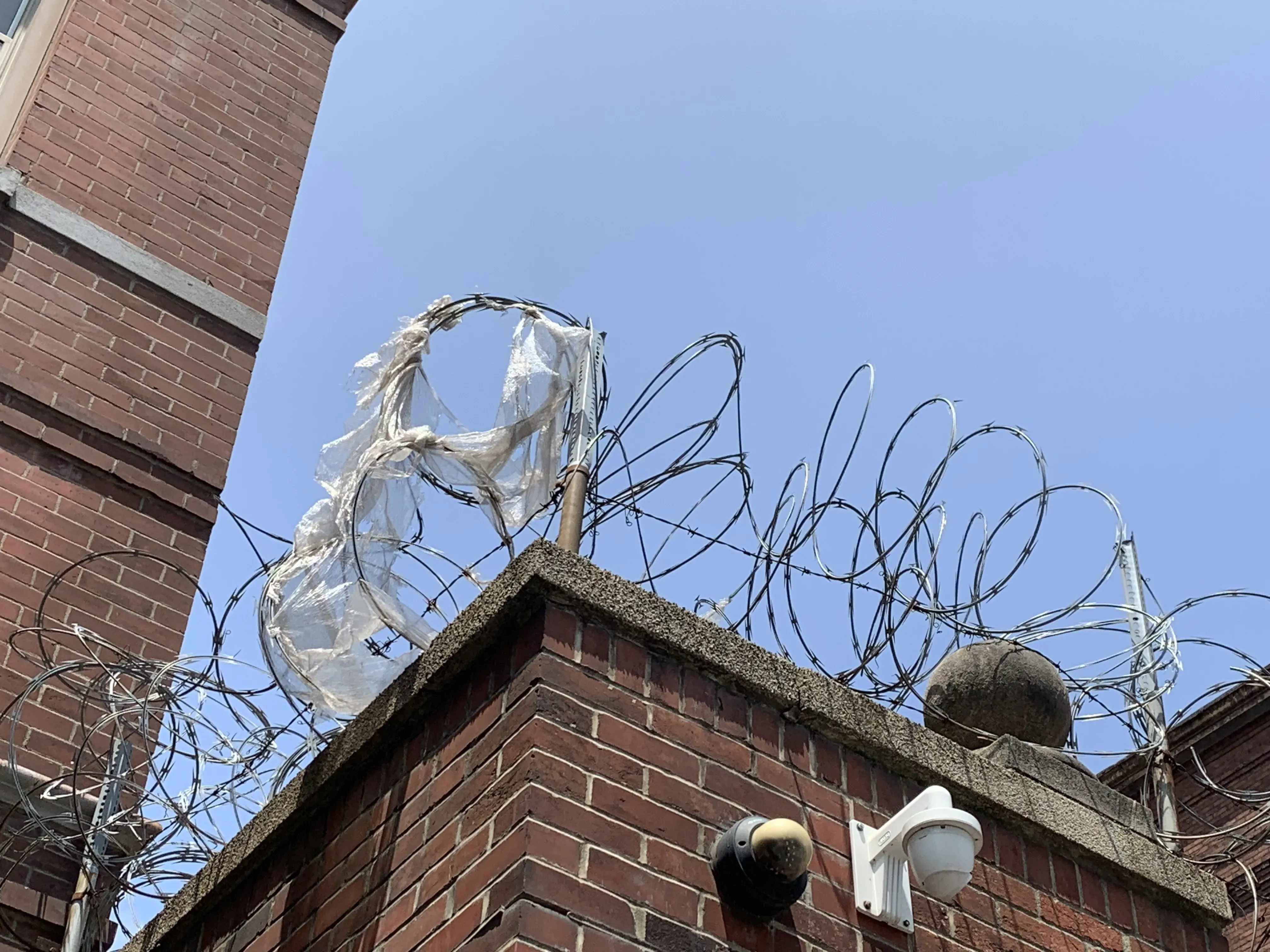 Barbed wire on roof of brick building